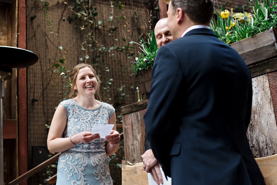A bride reads her vows to her groom during the wedding ceremony in Philly.
